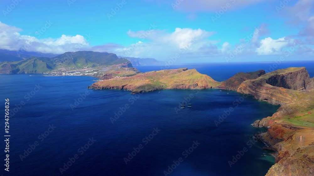 Exploring the stunning coastal landscape and vibrant waters near the island's shore during a clear day Exploring the stunning coastal landscape and vibrant waters near the island's shore during a clear day