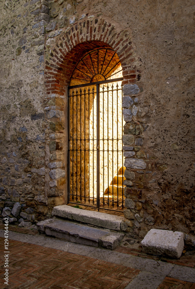 Fototapeta premium Ancient doorway lit up with golden light