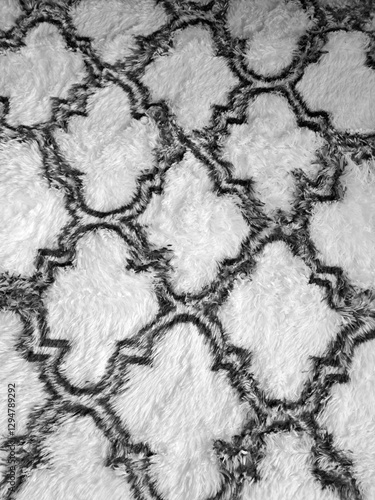 black and white cloverleaf style pattern on a fluffy carpet or rug