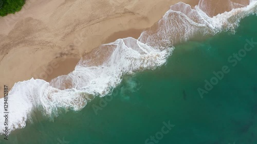 Huge turquoise waves breaking slowly on lonely sandy beach on Sri Lanka island near Tangalle town Hambantota District. Traveling or exotic asian countries aerial drone point view 4K rotating footage.