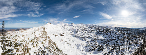 Panoramic view of the Pyrenees in winter. Border between Spain and France. St. Martin's rock. Snow covers the mountains and valleys. In the background you can see several important mountain peaks.