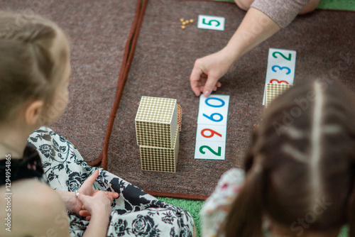 Focused Young Girls Learning Mathematics with Educational Tools