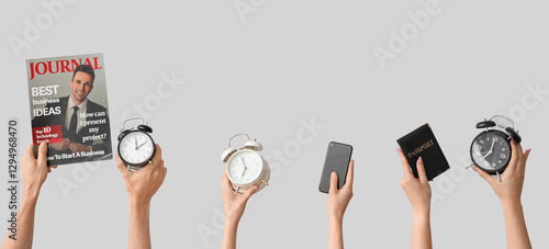 Hands holding alarm clocks,...