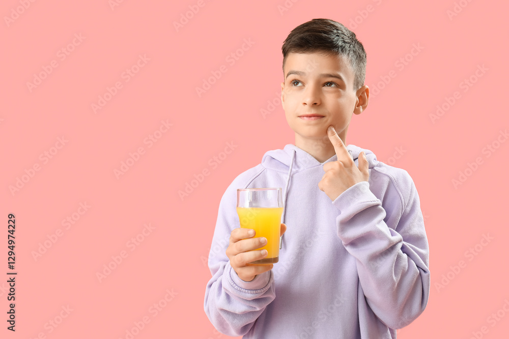 Thoughtful little boy with glass of orange juice on pink background Thoughtful little boy with glass of orange juice on pink background
