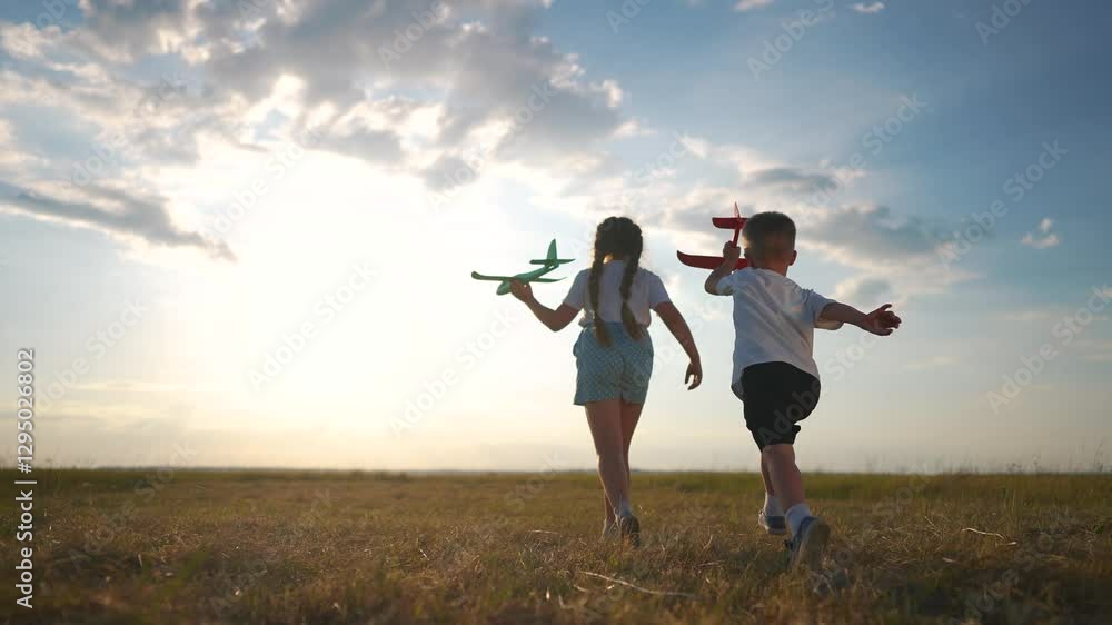 Plane is running through a forest with children in their childhood. Airplane toy field concept. plane parked next to crowd of children running. fun Child runs past plane parked park and runs around. Plane is running through a forest with children in their childhood. Airplane toy field concept. plane parked next to crowd of children running. fun Child runs past plane parked park and runs around.