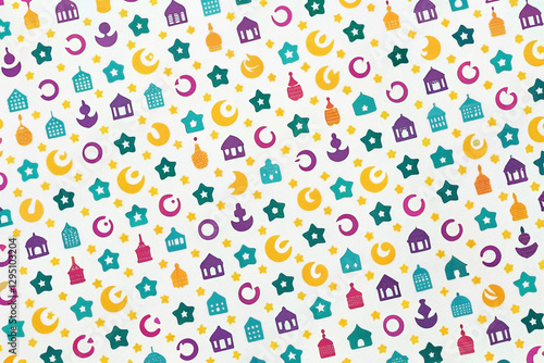 Colorful Islamic pattern background with moons, stars, and mosques.