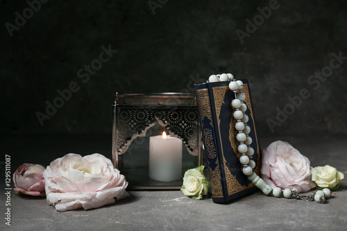 Bild auf Leinwand Fanoos with Koran and beautiful flowers on black grunge background