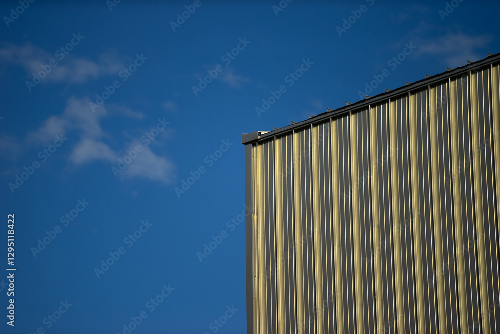 Modern Industrial Building Exterior with Blue Sky Background Modern Industrial Building Exterior with Blue Sky Background