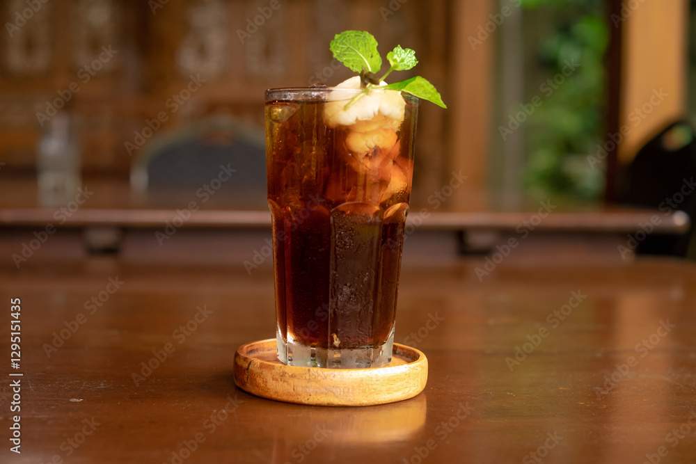 Leci Tea served elegantly with a slice of lemon on a wooden table, emphasizing presentation. Leci Tea served elegantly with a slice of lemon on a wooden table, emphasizing presentation.