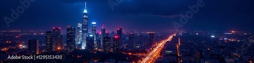 Colorful illuminated skyscrapers against dark sky, night, city