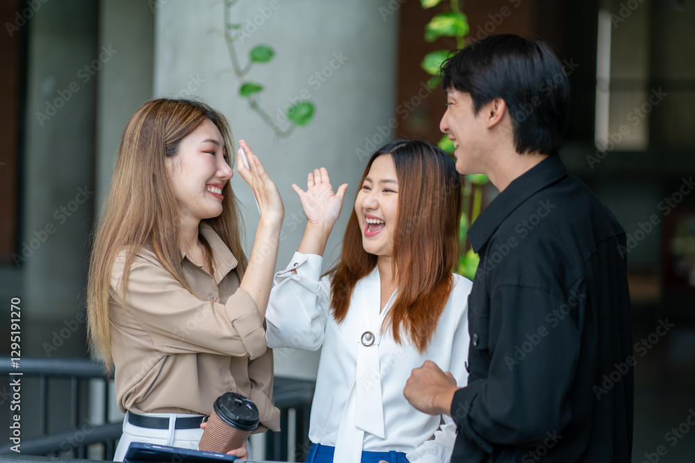 Fototapeta premium Group of Asian business people walking outside in front of office buildings.Southeast asian Business people group coworker working at outdoor city urban,communication or networking together concept.