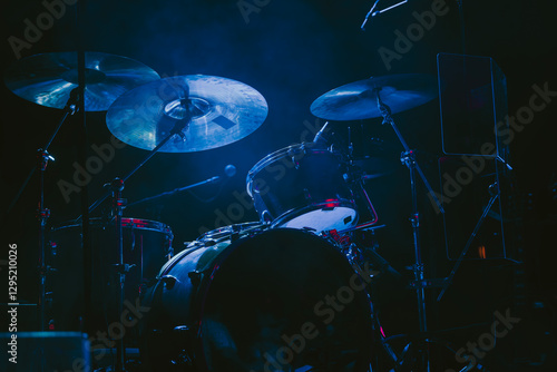 A Drum Kit on Stage waiting for a Concert to Start with a dark atmosphere and a spotlight
