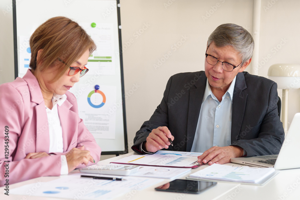Experienced executives reviewing company performance, discussing financial growth strategies, and planning business development. Experienced executives reviewing company performance, discussing financial growth strategies, and planning business development.