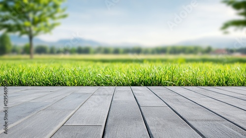 Gray Wooden Deck Over Lush Green Grass and Distant Hills
