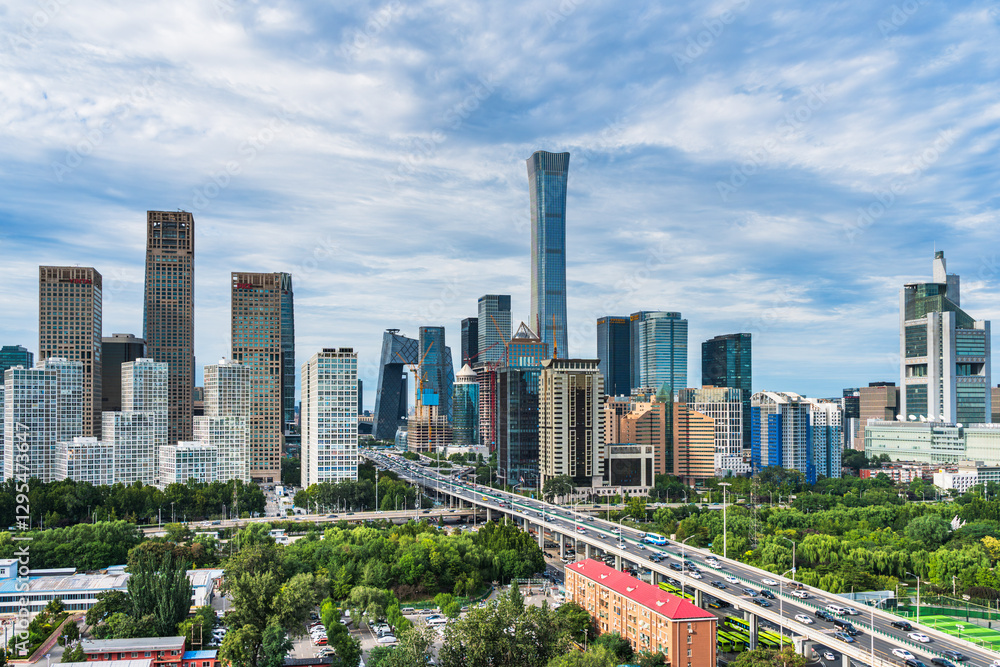 Naklejka premium The Guomao architectural complex in Beijing, China, under the blue sky and white clouds