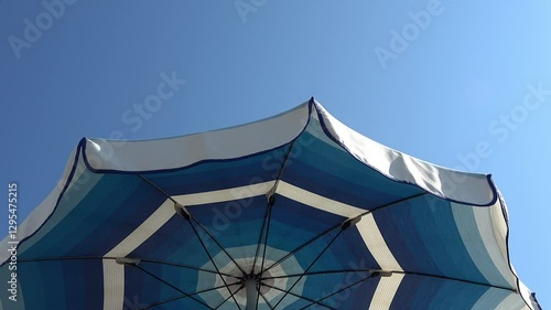 Wallpaper Mural White and shades of blue striped beach umbrellas. View from below. Blue sky. Relaxing context. Summer holidays at the sea. General contest and location Torontodigital.ca