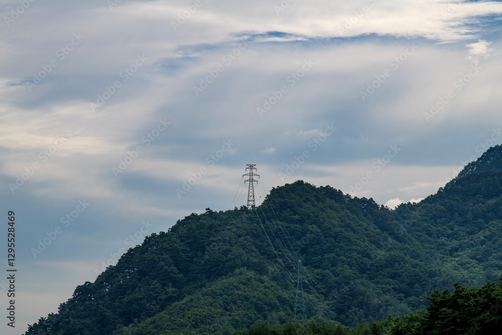 Obraz premium electricity pylon on the mountain on a cloudy day