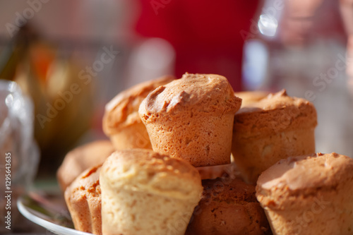 Wallpaper Mural A plate filled with golden-brown muffins, freshly baked and ready to enjoy, in warm natural lighting. Torontodigital.ca