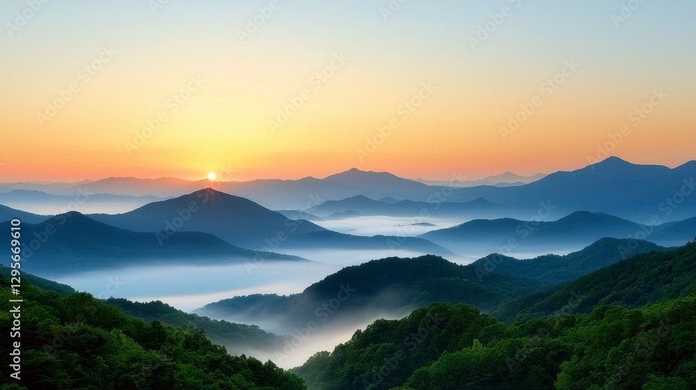 Obraz premium Misty Mountain Sunrise Layers of Blue and Green Hills Bathed in Golden Light