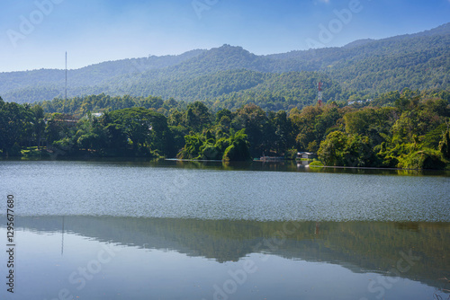 Obraz na płótnie a public place leisure travel landscape lake views at Ang Kaew Chiang Mai University and Doi Suthep nature forest Mountain views spring cloudy sky background with white cloud. w salonie