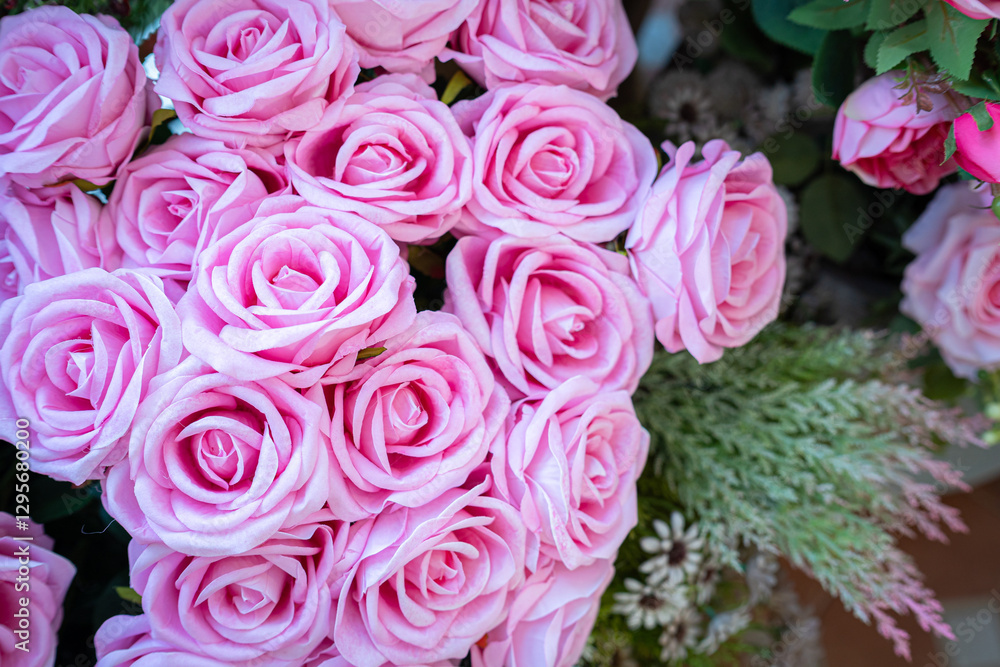 Valentine's day concept,close up Sweet color of artificial rose bouquet of red and pink roses Put with rose vase weddings interiors and decorations In a restaurant background