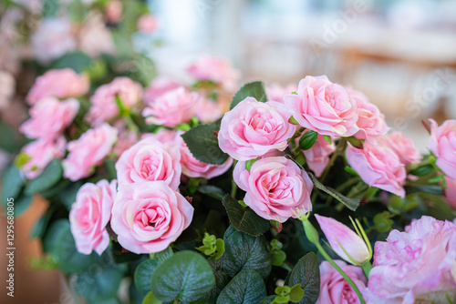 Valentine's day concept,close up Sweet color of artificial rose bouquet of red and pink roses Put with rose vase weddings interiors and decorations In a restaurant background