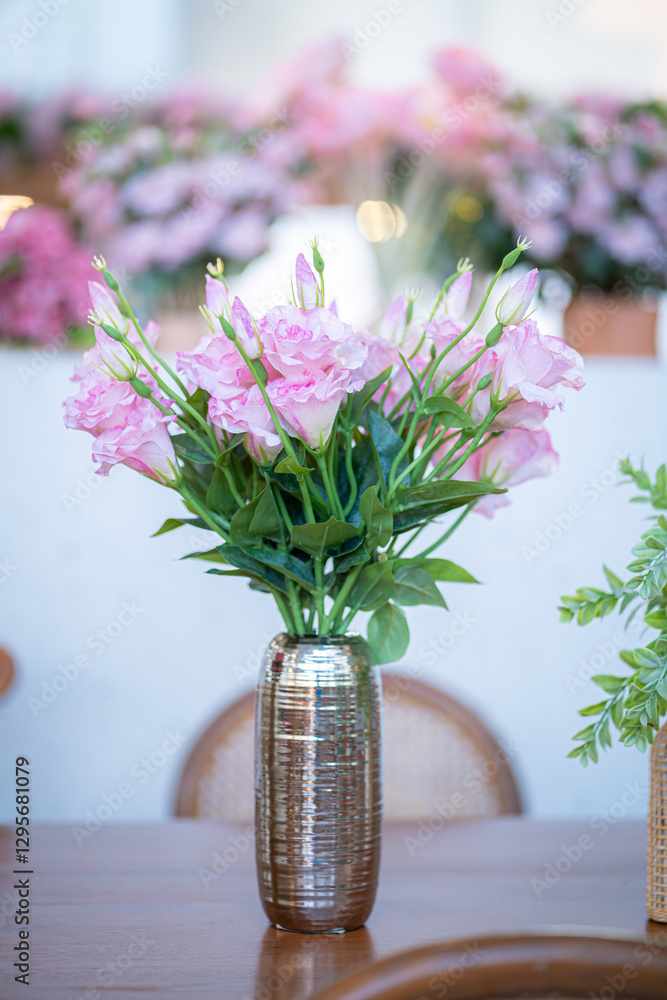 Valentine's day concept,close up Sweet color of artificial rose bouquet of red and pink roses Put with rose vase weddings interiors and decorations In a restaurant background
