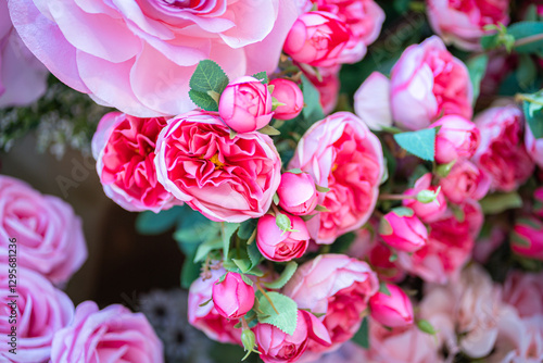 Valentine's day concept,close up Sweet color of artificial rose bouquet of red and pink roses Put with rose vase weddings interiors and decorations In a restaurant background