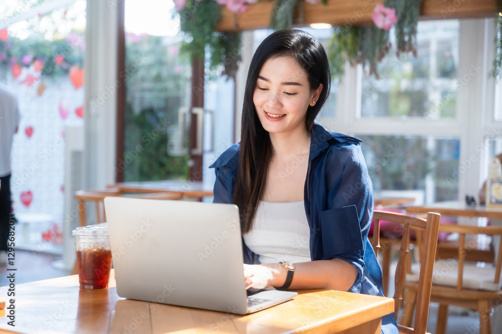 Asian freelance people business female talking making using casual working with laptop computer and coffee at home in the living room indoors artificial rose bouquet of red and pink roses rose vase