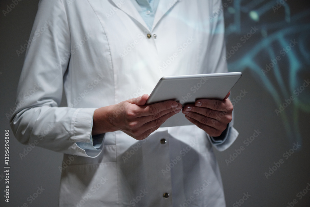 Cropped shot of unrecognizable scientist wearing white coat and holding tablet while giving presentation at medical conference, copy space Cropped shot of unrecognizable scientist wearing white coat and holding tablet while giving presentation at medical conference, copy space