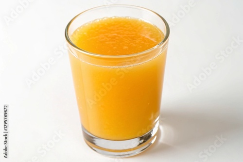 orange juice in a clear glass on white