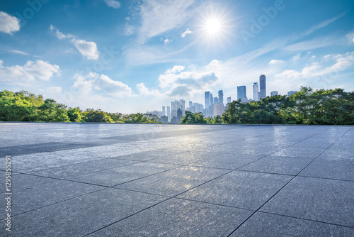 Empty square floor and green forest with city skyline on a sunny day