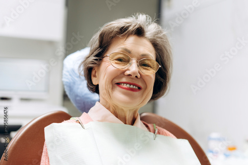 Senior woman smiling during dental checkup: oral health in old age