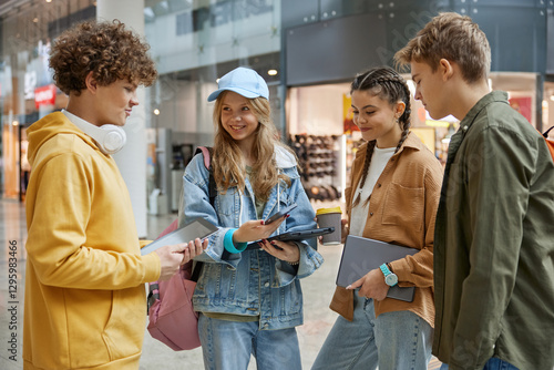 Group of diverse teenagers walking through shopping mall hall