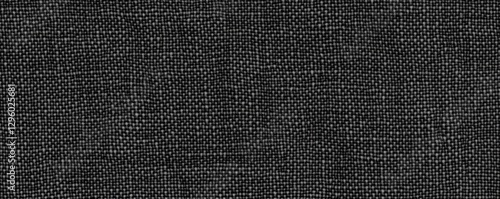 A textured black fabric surface with a subtle weave pattern, creating a sophisticated appearance ideal for upholstery or fashion.
