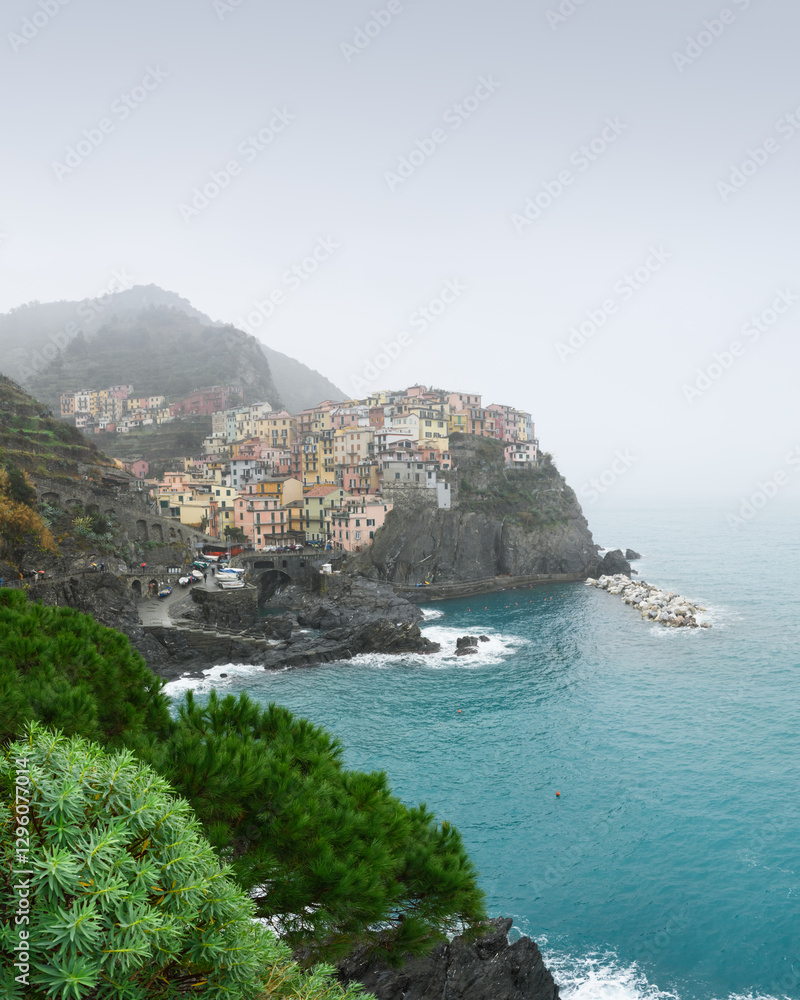 Fishing village Manarola in foggy day, Cinque Terre, Liguria, Italy. Landscape photography Fishing village Manarola in foggy day, Cinque Terre, Liguria, Italy. Landscape photography