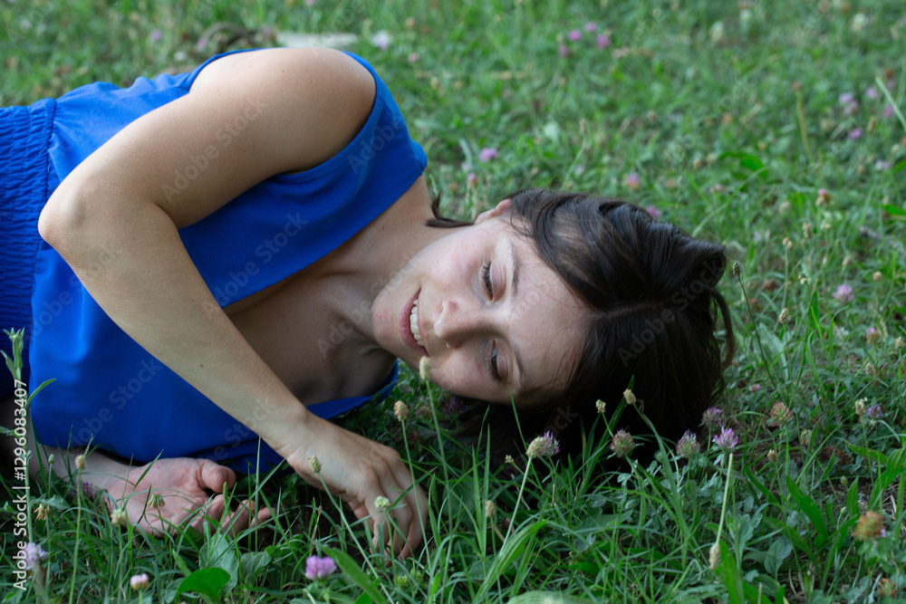 Young woman lying in grass enjoying nature Young woman lying in grass enjoying nature