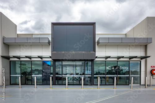 Photography A modern commercial building or shopping mall entrance features a sleek, contemporary design