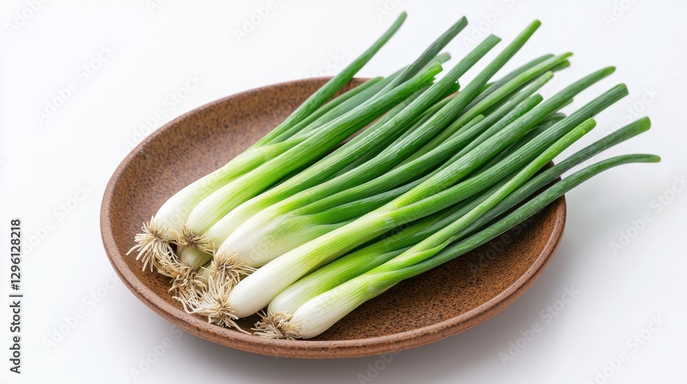 Fresh green onions arranged neatly on a brown plate, showcasing their vibrant green tops and white bases. Fresh green onions arranged neatly on a brown plate, showcasing their vibrant green tops and white bases.