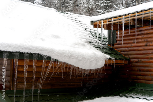 Dangerous icicles on the roof in winter