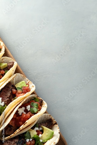 Colorful tacos arranged neatly, showcasing fresh ingredients and