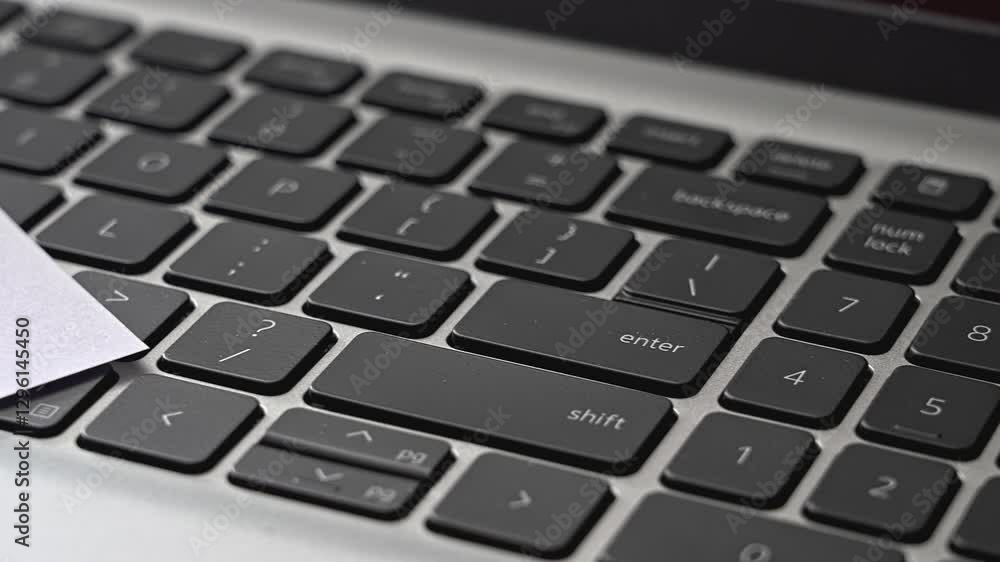 Close-up view of a modern laptop keyboard highlighting function keys and numeric keypad arrangement with pen and paper on top keyboard Close-up view of a modern laptop keyboard highlighting function keys and numeric keypad arrangement with pen and paper on top keyboard