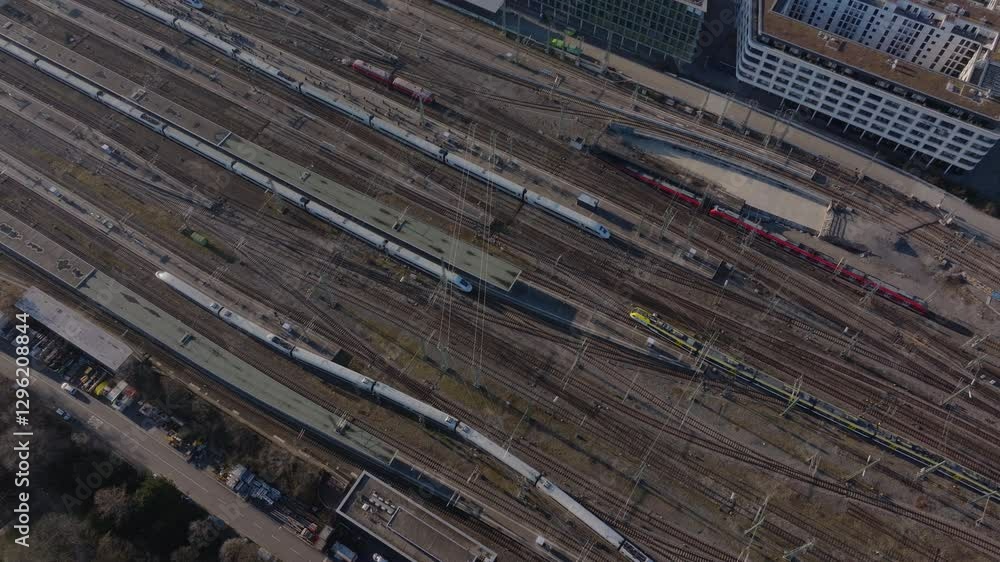 Aerial view from a tripod of high speed train nearing a central station, revealing contemporary transportation network and urban connectivity in motion
