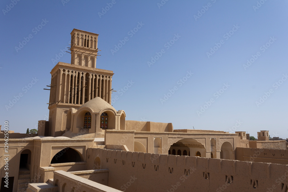 Fototapeta premium The spectacular wind catchers made with adobes in the historical mansion of Aghazadeh in Abarkuh, Yazd, Iran.