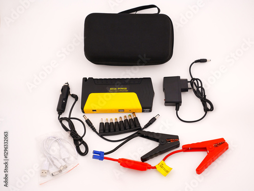 Power bank with the function of starting the car on a white background. The jump starter is suitable for motors, as a power source for laptops, phones, tablets and other gadgets. complete set photo