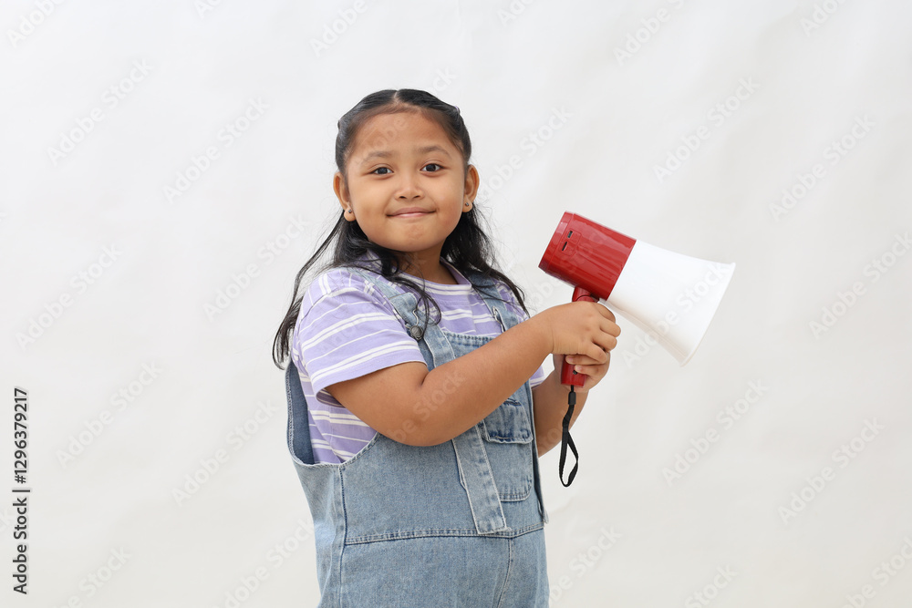 Asian little girl holding megaphone looking at camera smiling giving something announcement Asian little girl holding megaphone looking at camera smiling giving something announcement