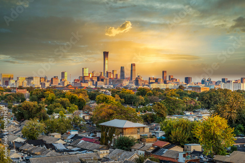 In Beijing, China, traditional dwellings and modern high-rise buildings make an interesting contrast under the setting sun