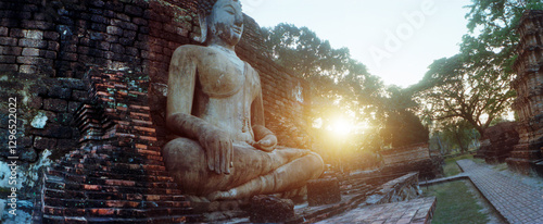 Panoramic view of statue of Buddha at sunset, Sukhothai Historical Park, Sukhothai, Thailand.