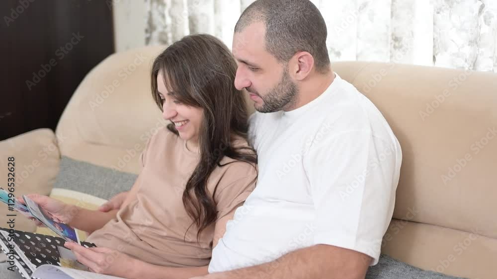 Loving couple family woman and man enjoying valentine's day, reading romantic letters and sharing a special moment together on the sofa Loving couple family woman and man enjoying valentine's day, reading romantic letters and sharing a special moment together on the sofa