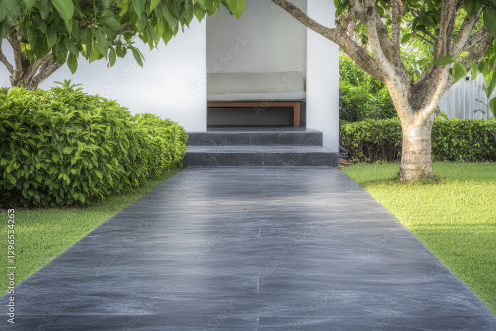 Naklejka premium Pathway leading to a serene outdoor seating area surrounded by lush greenery